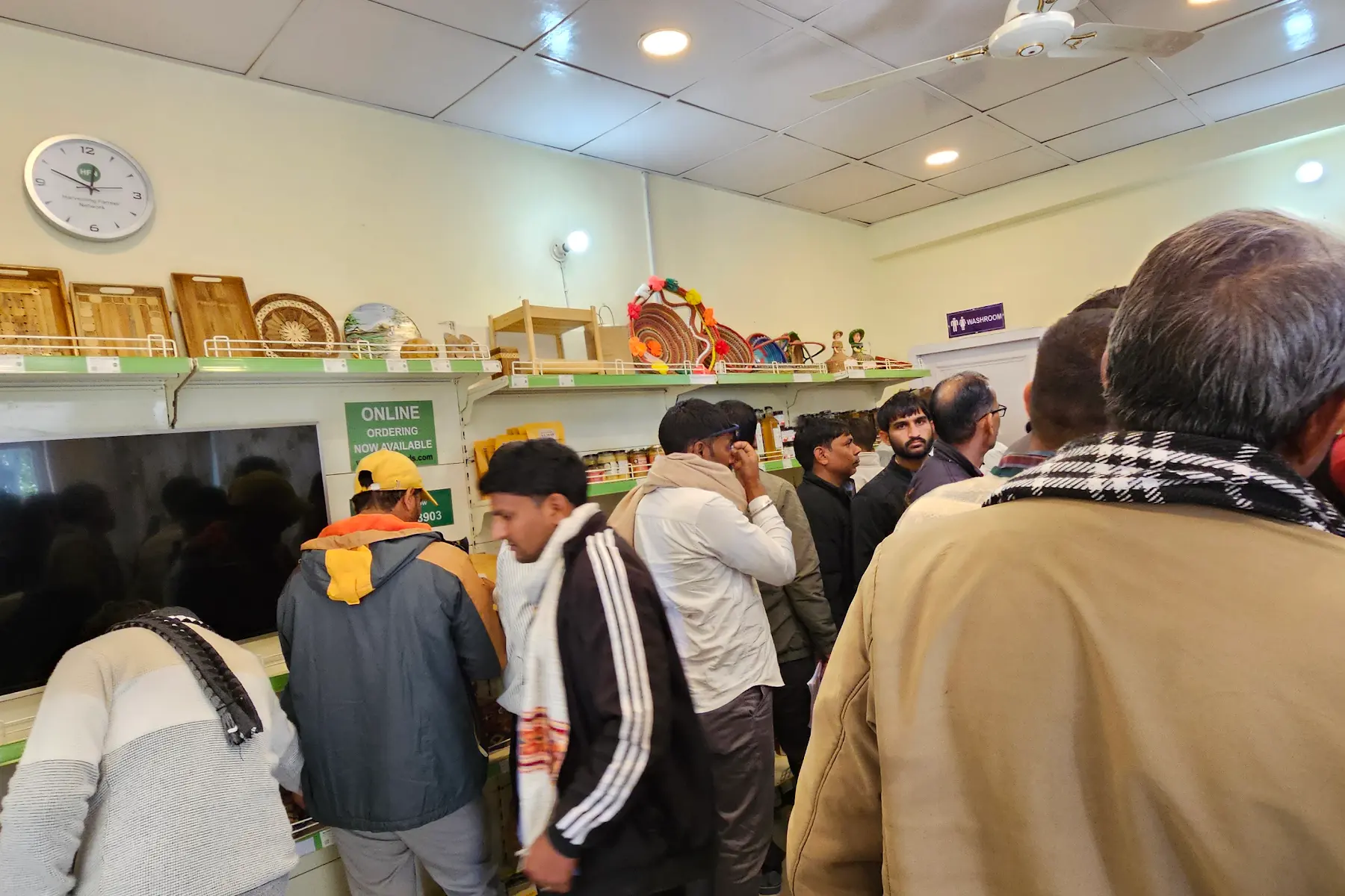 Visitors inside HFN Store looking at shelves during the inauguration.